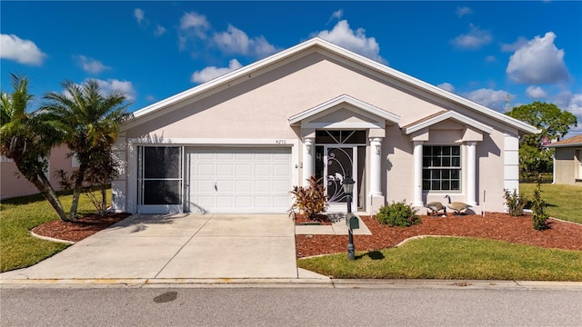 view of front of home with a front yard and a garage