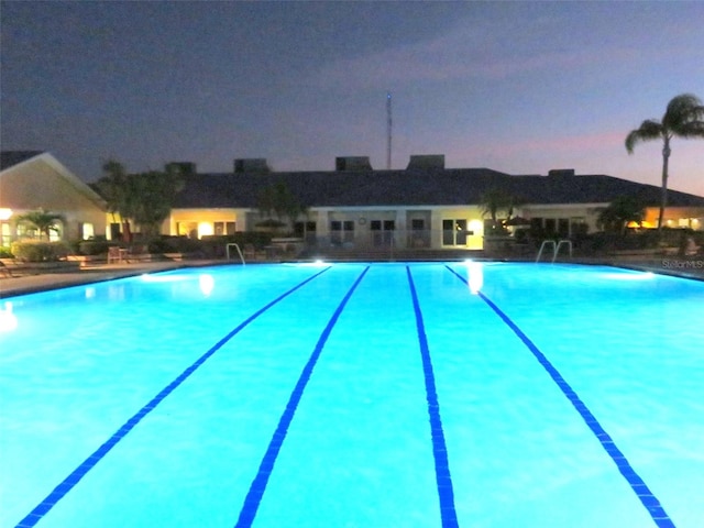 view of pool at dusk