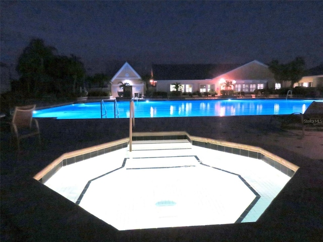 view of pool at night