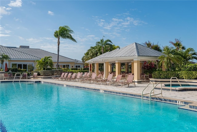 view of swimming pool with a patio and a community hot tub