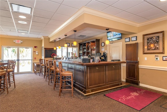 bar featuring crown molding, carpet, and pendant lighting