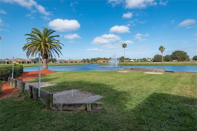 exterior space featuring a water view and a lawn