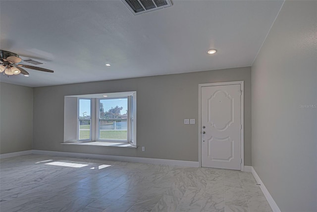 spare room featuring ceiling fan, marble finish floor, recessed lighting, baseboards, and visible vents