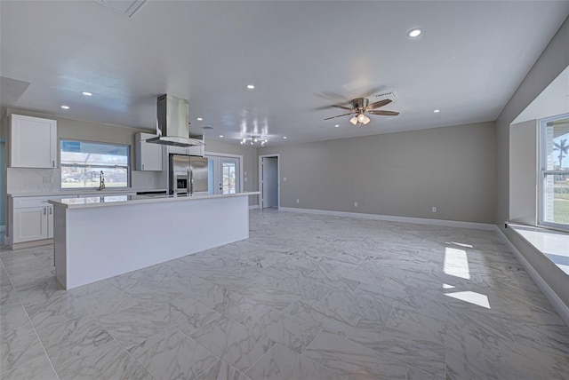 kitchen featuring tasteful backsplash, a kitchen island, stainless steel fridge with ice dispenser, island range hood, and white cabinetry