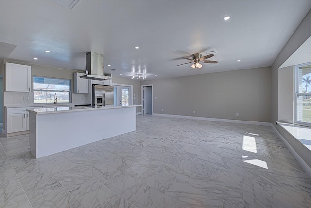 unfurnished living room featuring recessed lighting, a ceiling fan, baseboards, and marble finish floor