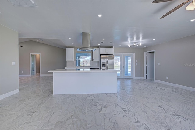 kitchen featuring island range hood, white cabinetry, stainless steel refrigerator with ice dispenser, a center island, and vaulted ceiling