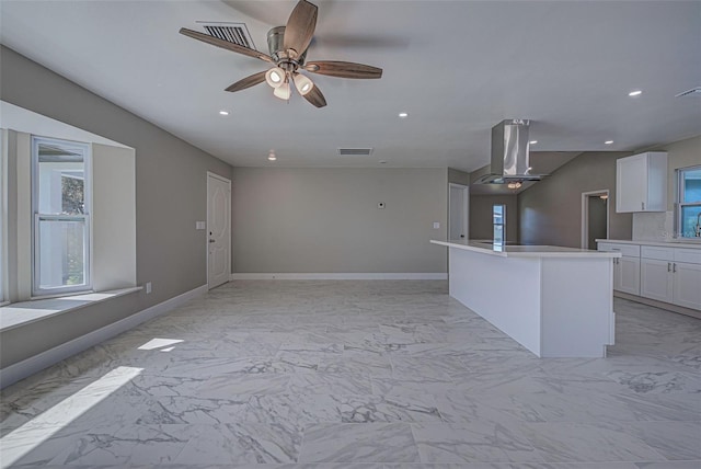 unfurnished living room featuring ceiling fan