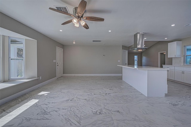 kitchen featuring a healthy amount of sunlight, range hood, and open floor plan