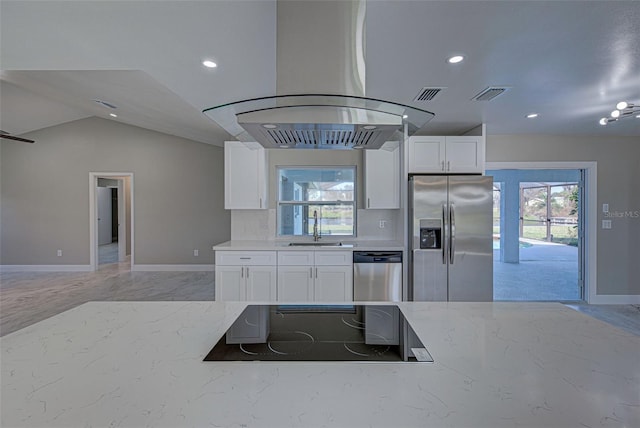 kitchen with white cabinets, sink, island exhaust hood, stainless steel appliances, and vaulted ceiling