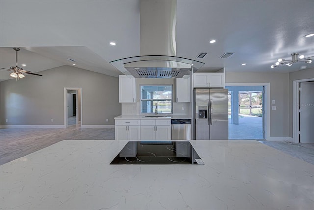 kitchen featuring island exhaust hood, sink, stainless steel appliances, white cabinets, and lofted ceiling