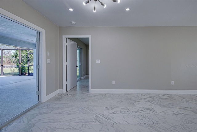 unfurnished room with a chandelier