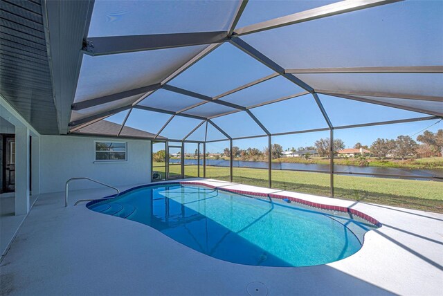 view of swimming pool with a lawn, glass enclosure, a water view, and a patio area