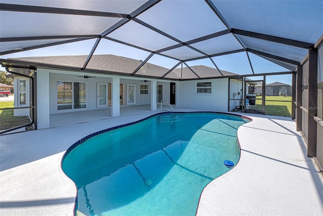 view of pool with a lanai, ceiling fan, and a patio