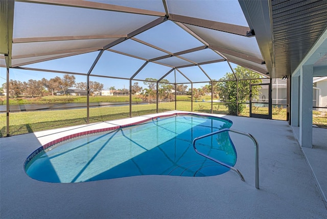 view of swimming pool featuring a yard, glass enclosure, and a patio area