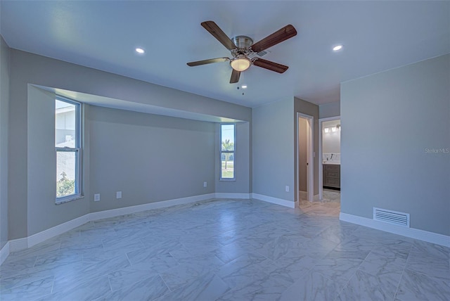 empty room featuring recessed lighting, ceiling fan, visible vents, and marble finish floor