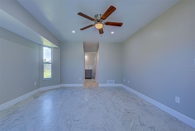 unfurnished room featuring a ceiling fan, baseboards, visible vents, and marble finish floor
