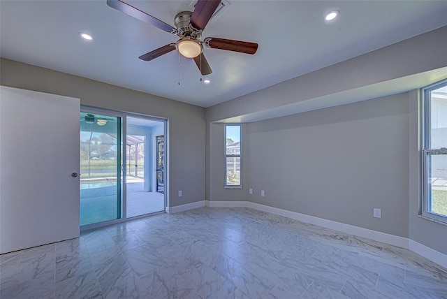 unfurnished room featuring a ceiling fan and marble finish floor