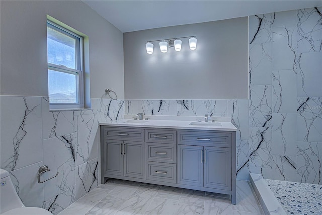 bathroom with vanity, tile walls, and a shower