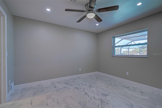 spare room featuring recessed lighting, a ceiling fan, marble finish floor, and baseboards