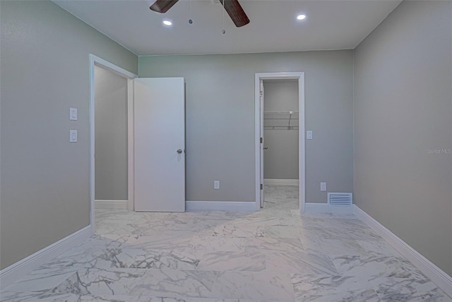 unfurnished bedroom with recessed lighting, baseboards, and marble finish floor