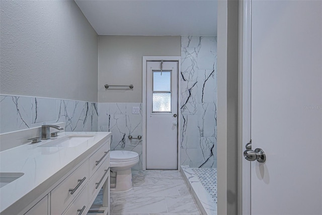 bathroom featuring a shower, tile walls, vanity, and toilet