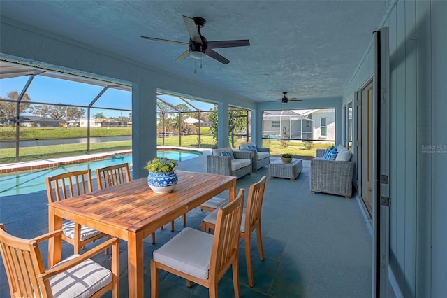 sunroom / solarium featuring an outdoor hangout area, a ceiling fan, and a pool