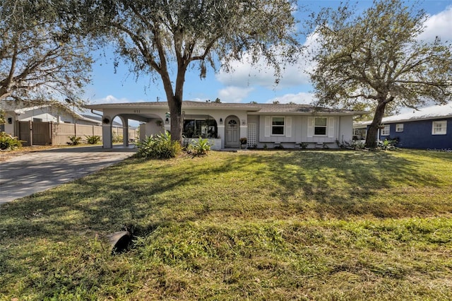 ranch-style home with a carport and a front lawn