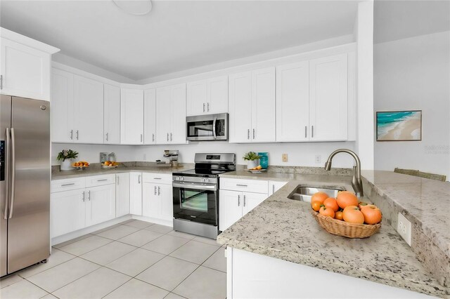 24083 Buckingham Way, Port Charlotte, FL 33980 - kitchen with white cabinets, light stone counters, stainless steel appliances, and a sink