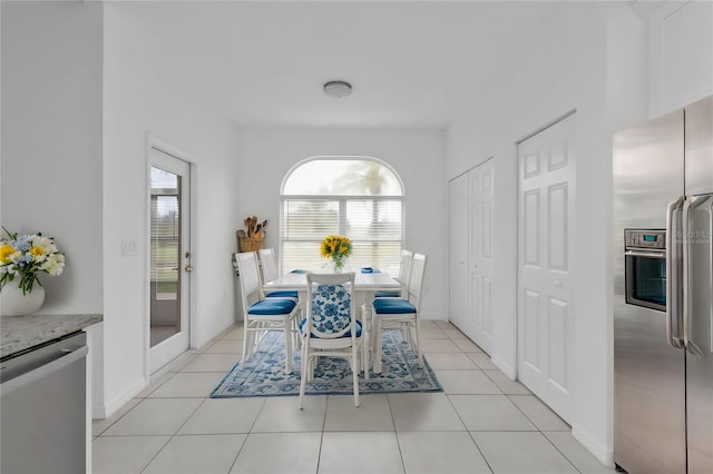 dining area featuring light tile patterned floors and a healthy amount of sunlight