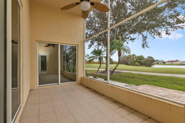 unfurnished sunroom with ceiling fan