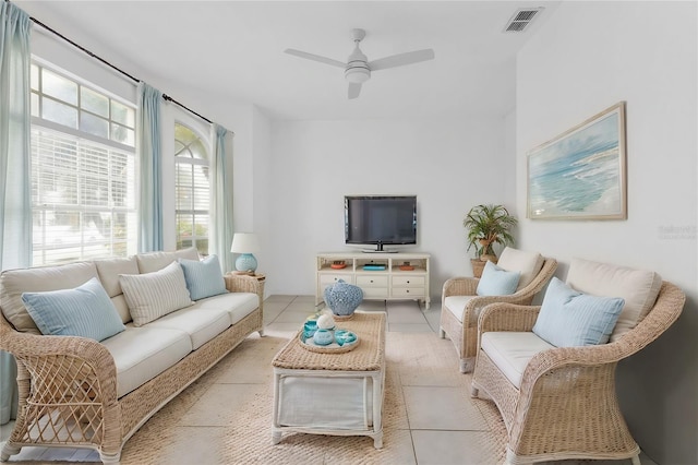 living room with ceiling fan, light tile patterned floors, and a healthy amount of sunlight