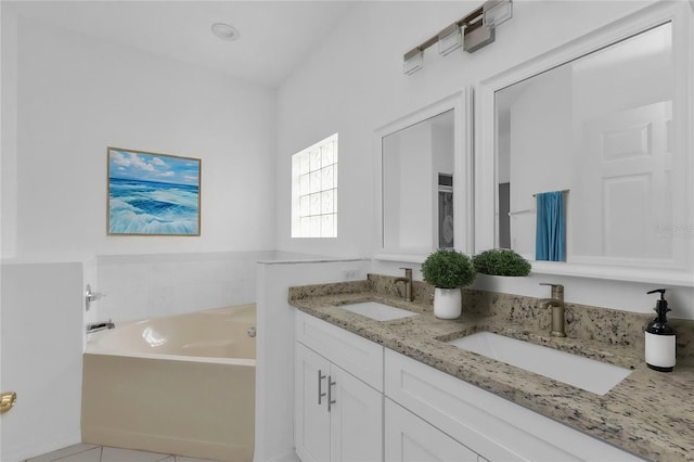 bathroom featuring a tub, tile patterned flooring, and vanity