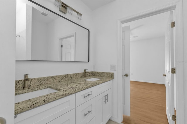 bathroom with hardwood / wood-style flooring and vanity