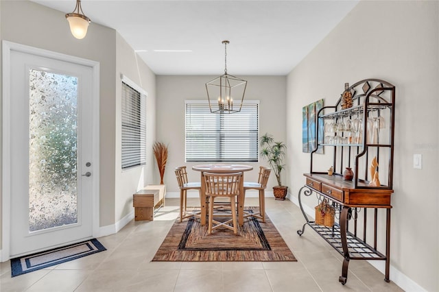 tiled dining space with a wealth of natural light and a notable chandelier