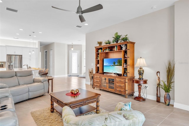 tiled living room featuring ceiling fan