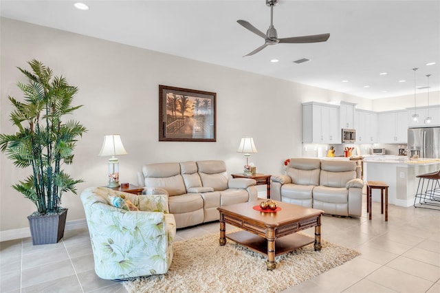 tiled living room featuring ceiling fan