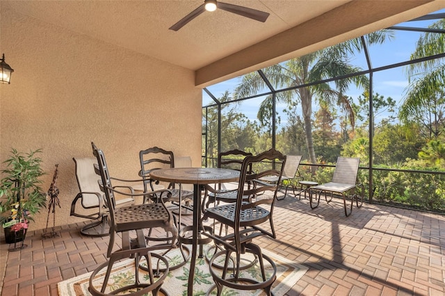 view of patio with ceiling fan and a lanai