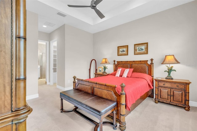 bedroom featuring connected bathroom, ceiling fan, and light colored carpet