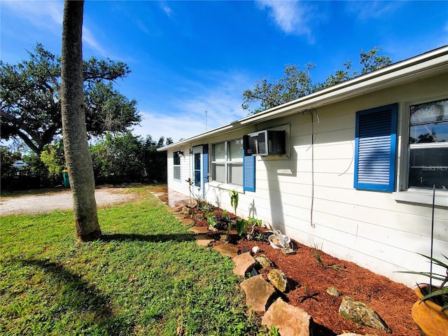 view of side of property with a lawn