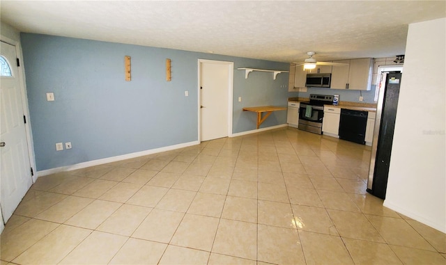 kitchen featuring ceiling fan, light tile patterned flooring, a textured ceiling, white cabinets, and appliances with stainless steel finishes