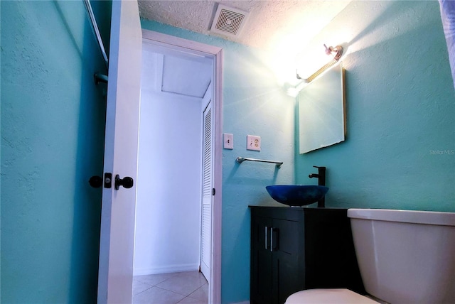 bathroom featuring tile patterned floors, vanity, and toilet