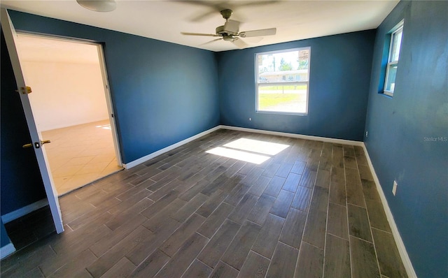 empty room featuring dark hardwood / wood-style floors and ceiling fan