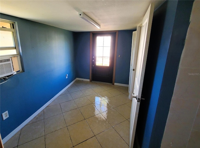 entryway featuring cooling unit and light tile patterned flooring