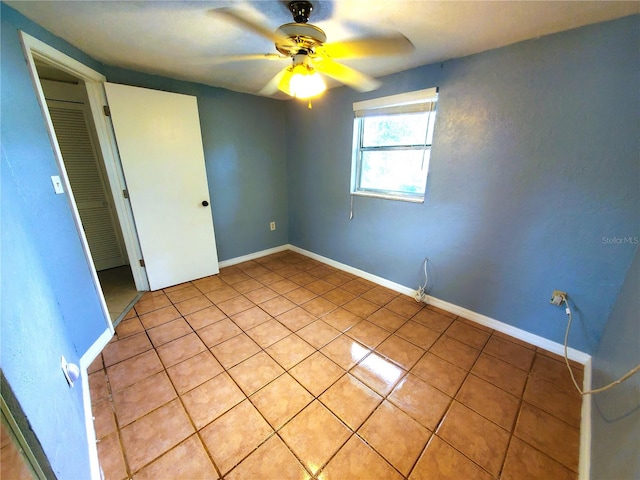 unfurnished bedroom featuring ceiling fan and light tile patterned flooring