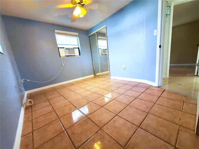 spare room featuring cooling unit, ceiling fan, and light tile patterned flooring