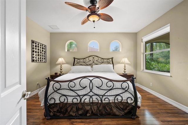 bedroom with ceiling fan and dark hardwood / wood-style flooring