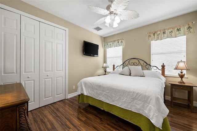 bedroom with dark hardwood / wood-style floors, a closet, and ceiling fan