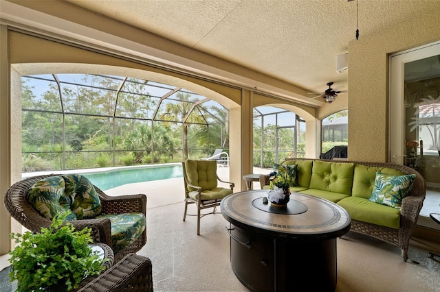 sunroom / solarium with a swimming pool and ceiling fan