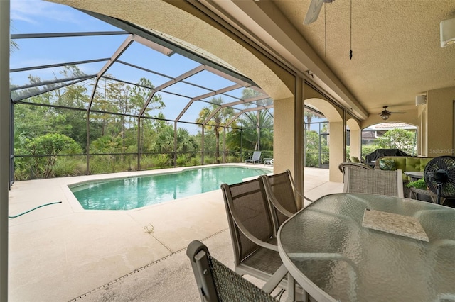 view of pool with a lanai, a patio area, and ceiling fan