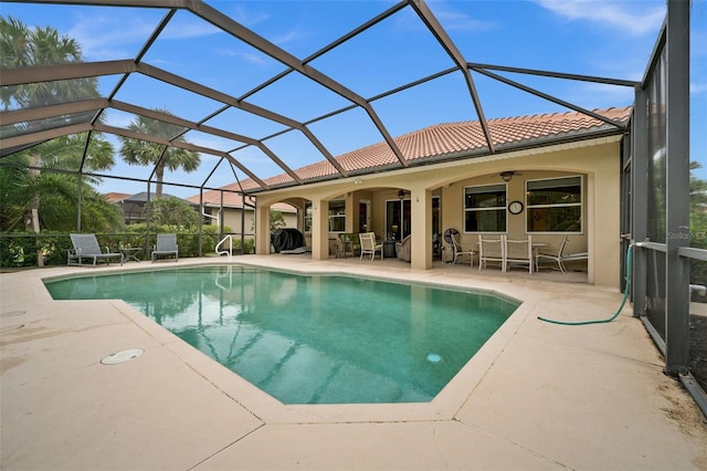 view of pool featuring a patio area, a lanai, and ceiling fan